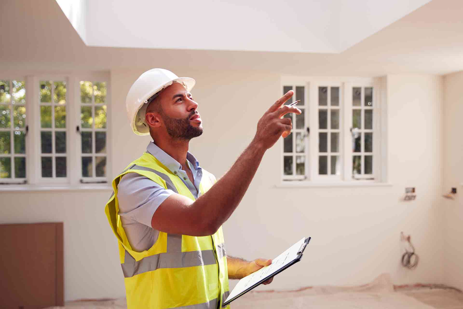 Third Party Wall Surveyors Bolton reviewing plans between two parties during a dispute